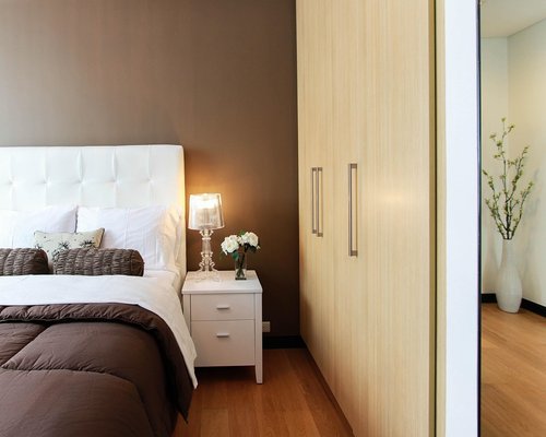 Soft bedside lighting illuminating a dark modern bedroom for midnight device check