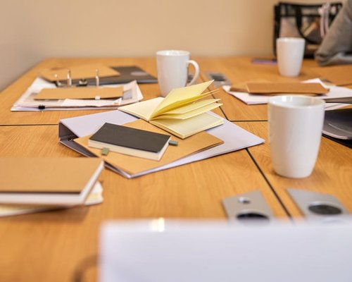 Bright workspace with gentle daylight scattering across a clean wooden office table